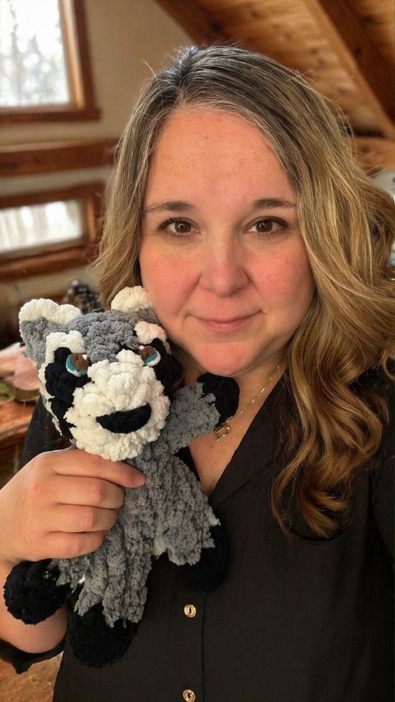 Jessica holding a handmade finger-knit stuffie.